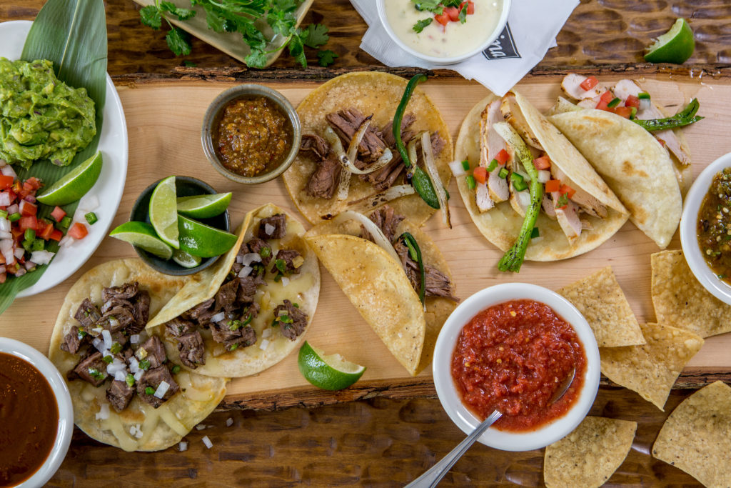 Try a sampling of street style, shredded brisket or chicken fajita tacos from Mi Cocina's Dinner Taqueria menu. 